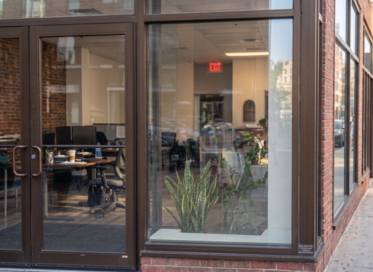 Exterior view of a ground floor Toronto office storefront featuring invisible security window film applied to its large glass windows and doors, providing clear, unaltered anti theft protection