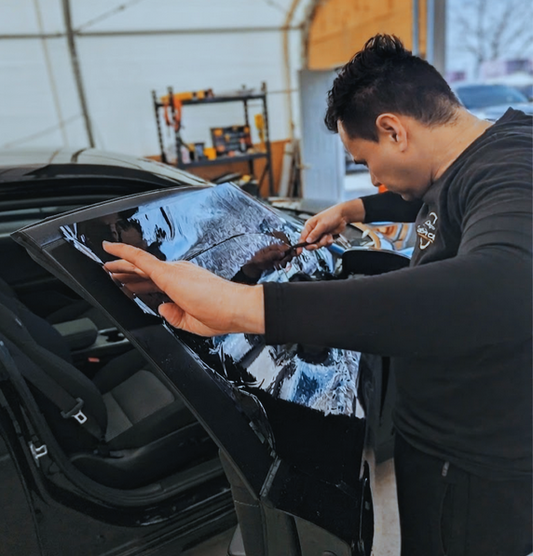 Expert installation of clear automotive security window film in Toronto, providing vehicles with invisible, high bond protection against shattered glass and theft.